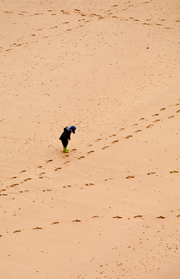  • Wandering the beach at Tenby Tenby is a delightful, small town on the southwest coast of Wales. This young child seemed to be enjoying walking is own “road” while also discovering the ways others had taken.